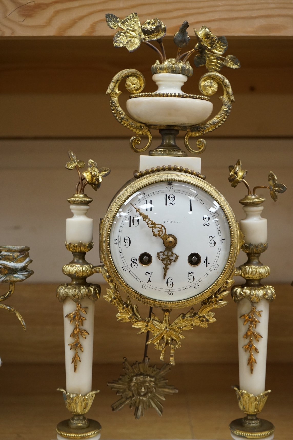 A 19th French white marble and gilt metal clock garniture, c.1900, striking on a bell, with pendulum, 45cm high